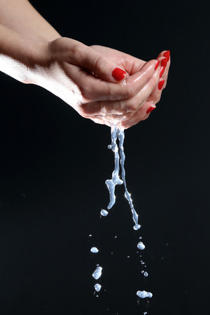 Washing hands Cleaning - woman washing hands on black backgroundの写真素材