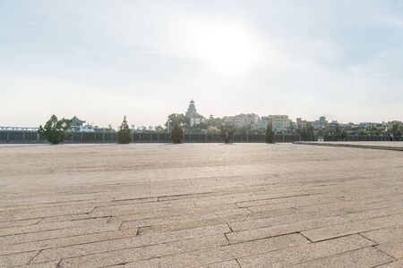 Square and Parking Lot under the Sunlight against Cityscapeの写真素材