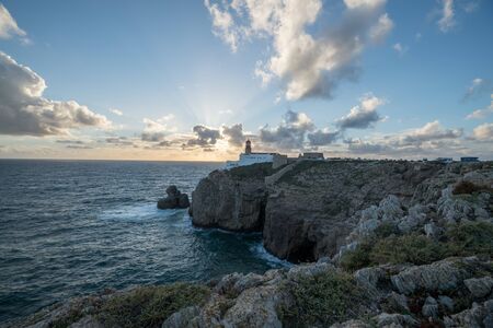 The lighthouse on Cliff at Cabo de Sao Vicente near Lagos in the South Portugal during the Sunsetの写真素材