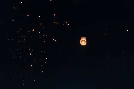 Lanterns flying in the sky during Chiang Mai lantern festivalの写真素材