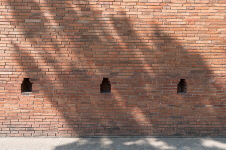 Red brick wall with sunlight and shadow, ancient Tha Phae Gate, Chiang Maiの写真素材