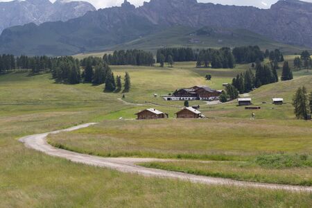 Rural road and small cabin on grassland in seiser alm, South Tyrol, Italy