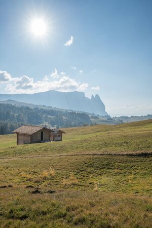 Landscapes on Alpe di Siusi with small cabins on grassland in autumn, South Tyrol, Italyの写真素材