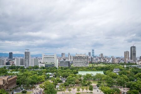 Cityscapes of the skyline in Osaka, with garden park in foregroundの写真素材