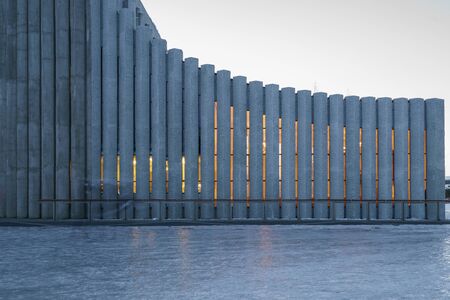 The wall background with columns of the cathedral Hallgrimskirkja church in the twilight, in...