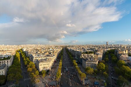 Aerial view of Paris City and the Avenue des Champs-Elysees with a rainbow among the city