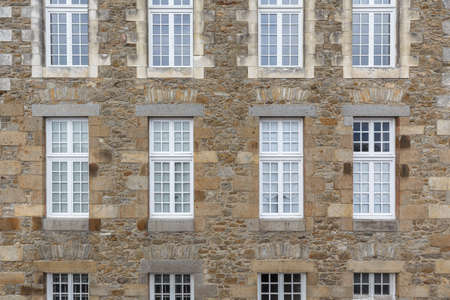 Brick walls background of ancient buildings with windows