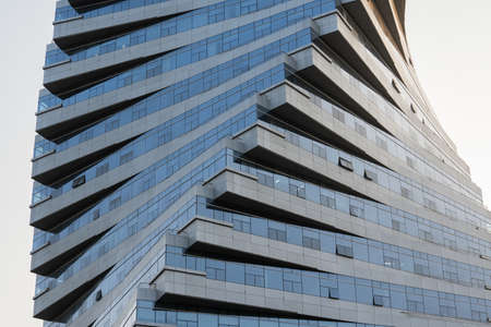 Abstract architecture, modern glass building. Close up view of a spiral modern office building at...