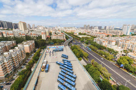 Aerial view of Xiamen BRT (Bus Rapid Transit) station with public buses and the viaducts over city...
