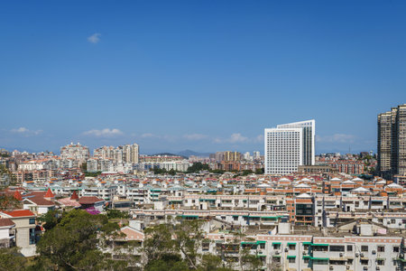 Xiamen city skyline with modern office buildings and residential district against blue skyのeditorial素材