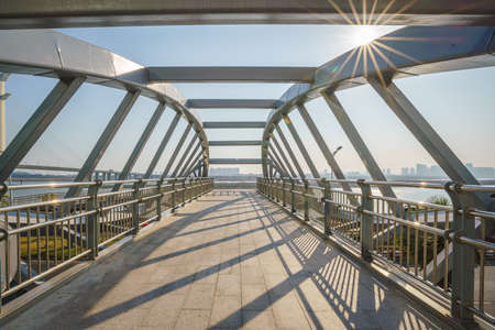 Urban flyover steel structure and sunlight at sunset
