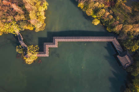 Aerial landscape of Hangzhou West Lake, the Yuhu Bay Scenic park with long covered bridgeの写真素材