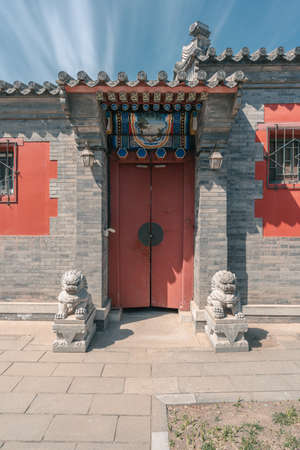 Ancient buildings with gray brick wall and Chinese lion stone in the Beijing Ancient Architecture Museumのeditorial素材