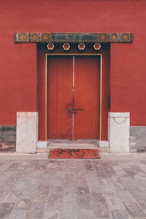 The ancient buildings with red wall, yellow or gray tile roof, door gate in the Forbidden City, Beijing, Chinaのeditorial素材