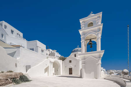 Traditional blue dome church and white bell tower in Santorini in Greeceの写真素材