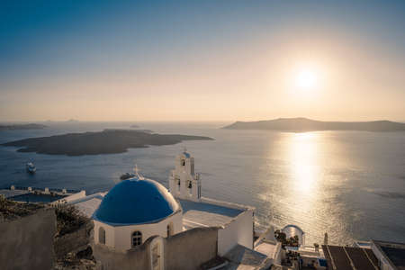 Traditional blue dome church and white bell tower in Santorini in Greeceの写真素材