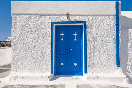 Blue wooden door with white wall backgroundの写真素材