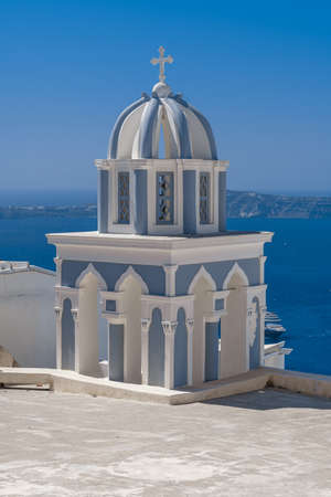 Traditional blue dome church and white bell tower in Santorini in Greeceの写真素材