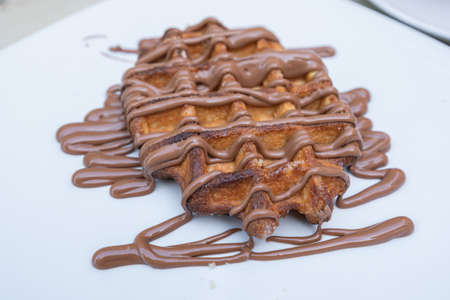 Close up view of waffle with honey and walnut