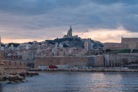 The Old Port and Basilica of Notre Dame de la Garde at dusk in Marseille, Franceのeditorial素材