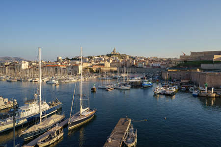 The Old Port and Basilica of Notre Dame de la Garde at dusk in Marseille, Franceのeditorial素材
