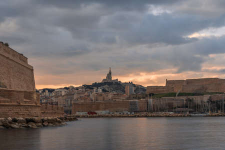 The Old Port and Basilica of Notre Dame de la Garde at dusk in Marseille, Franceのeditorial素材