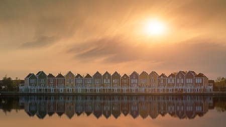 Colorful houses beside the lake at dusk in Houten, Utrecht, Nehterlandsの写真素材