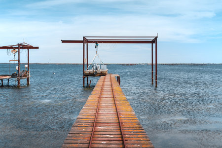 Wooden piers and boats for the oyster farm in Etang de Thau in South Franceの写真素材