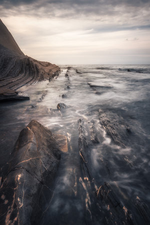 Sunset at the Flysch geological coastline, with Flysch formations in Zumaya in the Basque Country,...