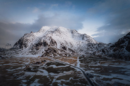 Aerial view of winter landscapes, snowcapped mountains and frozen road in Lofoten Islands in Norwayの写真素材