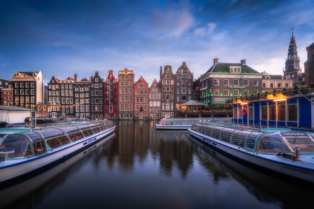 Sunset view of the famous historic center with lights, bridges, canals and traditional Dutch houses in Amsterdam, Netherlandsの写真素材
