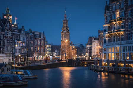 Evening panoramic view of the famous historic center with lights, bridges, canals and traditional Dutch houses in Amsterdam, Netherlandsの写真素材