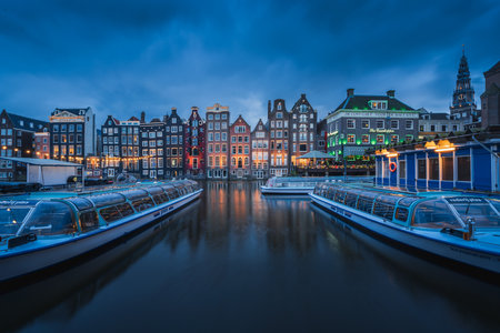 Evening panoramic view of the famous historic center with lights, bridges, canals and traditional Dutch houses in Amsterdam, Netherlandsの写真素材