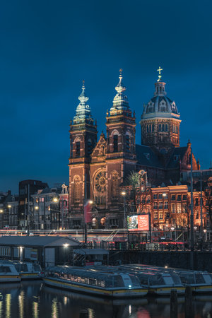 Basilica of Saint Nicholas and canal landscape at night, Amsterdam, Netherlandsの写真素材