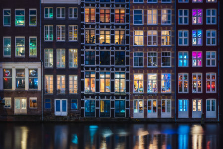 Colorful window of the traditional riverside houses at night in Amsterdam, Netherlandsの写真素材