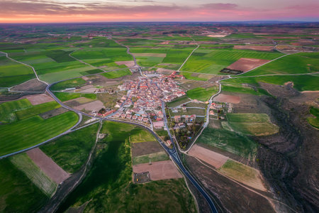 Aerial view of a rural town surrounded by idyllic farmlandの写真素材