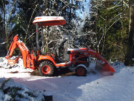 Tractor on the snow in winterの写真素材