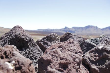 Volcano Teide and blue sky, lava rocks landscape grass, bushes, the ground is covered in lava. Parque nacional del Teide, Canary Islands, Spainの写真素材