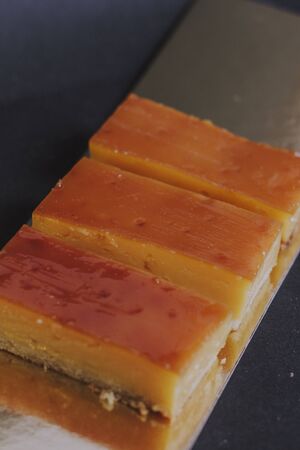 Homemade version of spanish sweet dessert called Crema Catalana. Gold plate and black backgroundの写真素材