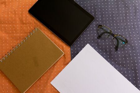 Minimal work space. Office concept with tablet, glasses, notebook and sheet