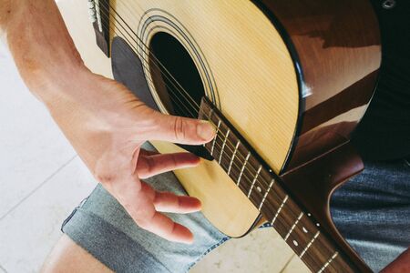 Guy playing on acoustic guitarの写真素材