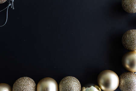 Christmas decoration yellow gold balls with black background. Christmas balls. 2020 Merry christmas