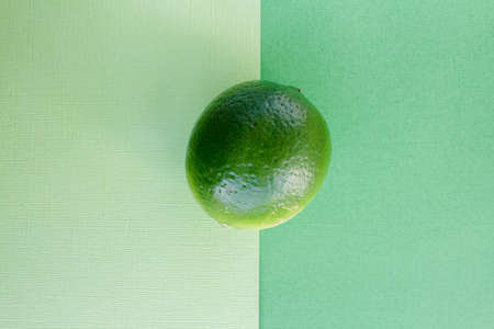 One fresh green lime overhead view lemon backgroundの写真素材