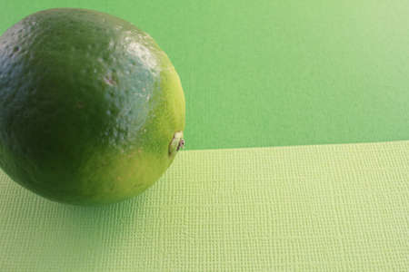 One fresh green lime overhead view lemon backgroundの写真素材