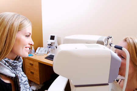 Optician explaining fluid pressure test to client