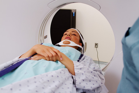 Young woman patient laying on x-ray tableの写真素材
