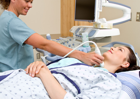 Patient having throat ultrasound completed at hospital