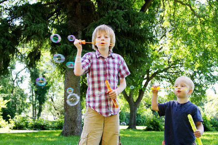Little brother copying big brother blowing bubblesの写真素材