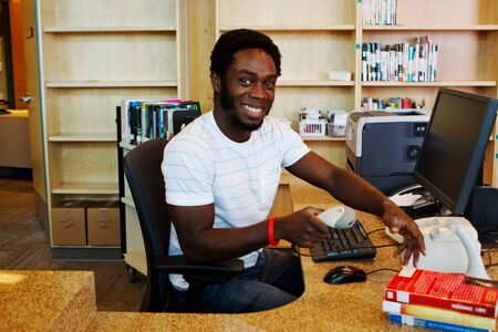 African librarian checking in books