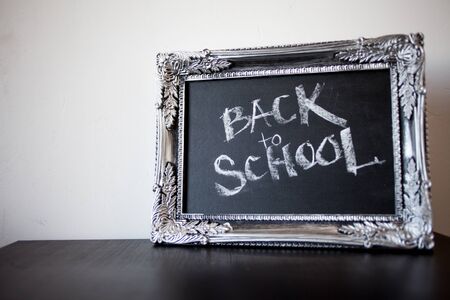 Back to school, chalk in a vintage frame. Text on chalkboard. Elite school, conceptの写真素材